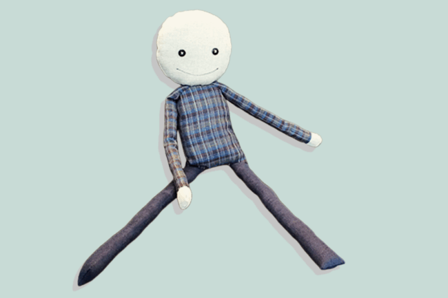 Kairos Stoffpuppe – handgefertigte Puppe als Begleiter für Coaching und Workshops, Produktfoto auf pastellblauem Hintergrund